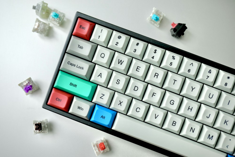 A white mechanical keyboard with colorful accent keys